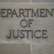 A “Department of Justice” sign is seen on the wall of the US Department of Justice building in Washington, DC on April 18, 2019.